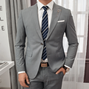 man in light gray suit against soft indoor backdrop